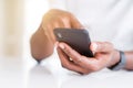 Close up of african american man hands using smartphone Royalty Free Stock Photo