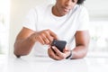 Close up of african american man hands using smartphone and smiling Royalty Free Stock Photo