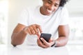 Close up of african american man hands using smartphone and smiling Royalty Free Stock Photo