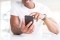 Close up of african american man hands using smartphone and smiling Royalty Free Stock Photo