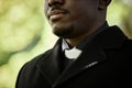 Close up of African American priest at outdoor funeral Royalty Free Stock Photo