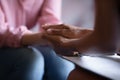 Close up African American psychotherapist holding patient hands, expressing empathy