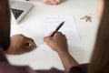 Close up of African American spouse signing property purchase co Royalty Free Stock Photo