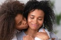 Close up African American teen daughter embracing smiling mother Royalty Free Stock Photo