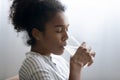 Close up African American woman enjoying drinking pure mineral water Royalty Free Stock Photo