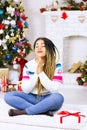 Close up of african american woman make a Christmas wish. New Year decorations and winter holiday home background. Merry Xmas gift Royalty Free Stock Photo