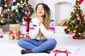 Close up of african american woman make a Christmas wish. New Year decorations and winter holiday home background. Merry Xmas gift Royalty Free Stock Photo
