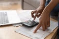 Close up African American woman using calculator, calculating finance