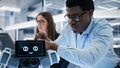 Close Up of an African Engineer Using a Screwdriver While Developing a Robot Dog Concept. Black Royalty Free Stock Photo