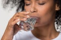 Close up african millennial female holding glass drinking water Royalty Free Stock Photo