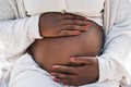 Close up of african pregnant woman holding her belly - Focus on hands Royalty Free Stock Photo