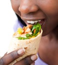 Close up of an african woman devouring a burrito Royalty Free Stock Photo