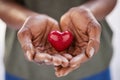 Close up of african woman hands holding red heart in solidarity Royalty Free Stock Photo