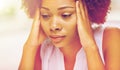 Close up of african young woman touching her head Royalty Free Stock Photo