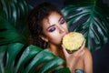 Close-up of afro american beautiful girl posing in tropical forest Royalty Free Stock Photo