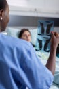 Close-up of afro american nurse analyzing lungs x-ray checking healdcare recovery Royalty Free Stock Photo