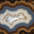 Close-up of an agate geode showcasing concentric layers of brown, blue, and white. Royalty Free Stock Photo