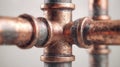Detailed view of a weathered copper plumbing pipe joint with visible connections and textured surface showing signs of aging and Royalty Free Stock Photo