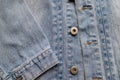 Close up aged denim texture. Old blue jeans jacket with stiched