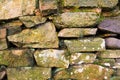 Mossy old dry stone wall close up. Royalty Free Stock Photo