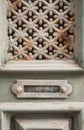 Close-up of an aged, green painted door with intricate metal grillwork and a letter slot Royalty Free Stock Photo