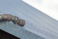 Close-up of an aged PVC pipe used for rain drainage on a rooftop. Royalty Free Stock Photo