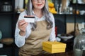 Close up of aged saleswoman holding credit card and box