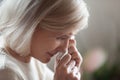 Close up of disappointed aged woman wiping tears crying Royalty Free Stock Photo