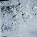 Up of air bubbles trapped in ice showcasing a range of bubble sizes with Royalty Free Stock Photo