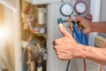 Close up of Air Conditioning Repair, repairman on the floor fixing air conditioning system Royalty Free Stock Photo