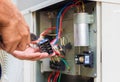 Close up of Air Conditioning Repair, repairman installing magnetic contactor and fixing air conditioning system Royalty Free Stock Photo