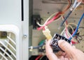 Close up of Air Conditioning Repair, repairman test, checking and repair of magnetic contactor and fixing air conditioning system