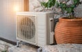 Air heat pump outdoor unit against wall of Greek house. Royalty Free Stock Photo