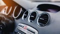 Close-Up Of Air Vent In Car. Red emergency button on a dashboard of car.