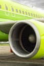 close-up of aircraft engine. green airplane and turbine detail on cloudy sky background at dawn