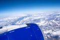 Close up of airplane engine with snow mountains and clouds in the background