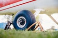 Close-up airplane road wheel locked in airfield parking lot Royalty Free Stock Photo