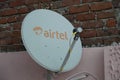 Close up of an Airtel dish installed on the roof of a house. view of Airtel Digital DTH Dish Antenna. Airtel Dish fixed at the top