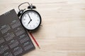 Close up of alarm clock, pencil and calendar on the table, planning for business meeting Royalty Free Stock Photo