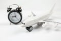 Close-up of an alarm clock and a toy plane on a white background Royalty Free Stock Photo