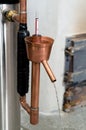 Close-up of alcohol distillation and brandy production with copper condenser. Traditional method of distilling whiskey, vodka and