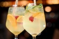 Close-up of alcohol drink of raspberry mojito in glasses with straw and ice cubes. Royalty Free Stock Photo