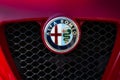 Close-up of the Alfa Romeo brand logo on the front radiator grille of a classic luxury sports car Royalty Free Stock Photo