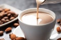 close-up of almond milk stirring in coffee