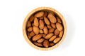 Close up of almonds nut seeds isolated in wooden bowl against top view on white background and clipping path Royalty Free Stock Photo