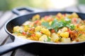 close-up of aloo gobi in a cast iron skillet