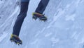 CLOSE UP Alpinist sticks his crampons in the ice while climbing up frozen stream