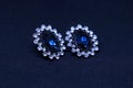 A close up of amazing earrings made of white gold and blue and white diamonds Royalty Free Stock Photo