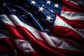 A close-up of the American flag waving in the wind, showcasing its vibrant colors, 50 stars, and 13 stripes, against a dark Royalty Free Stock Photo