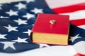 Close up of american flag, wedding rings and bible Royalty Free Stock Photo